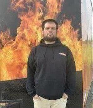 SERVPRO Technician in front of a logo truck