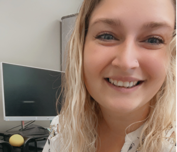 Women with blonde hair smiling in front of camera