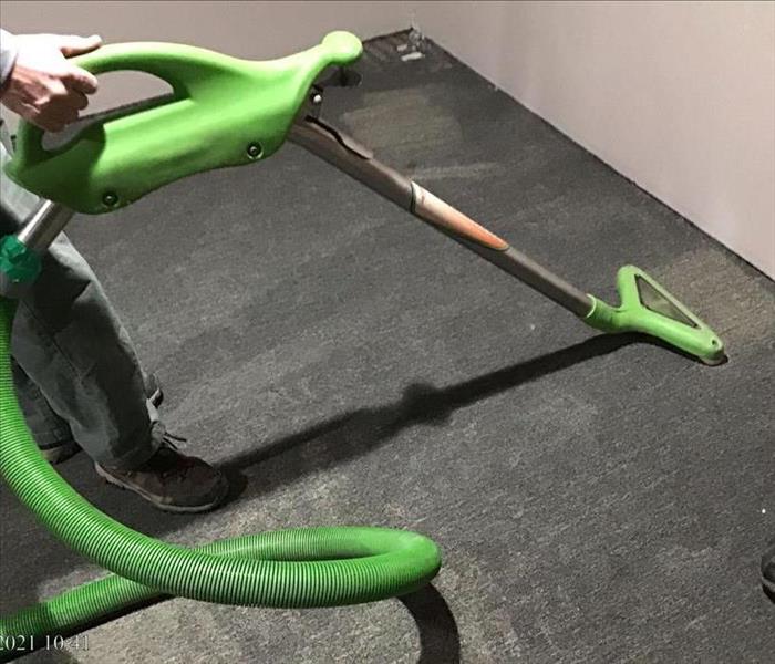 man extracting water from carpet